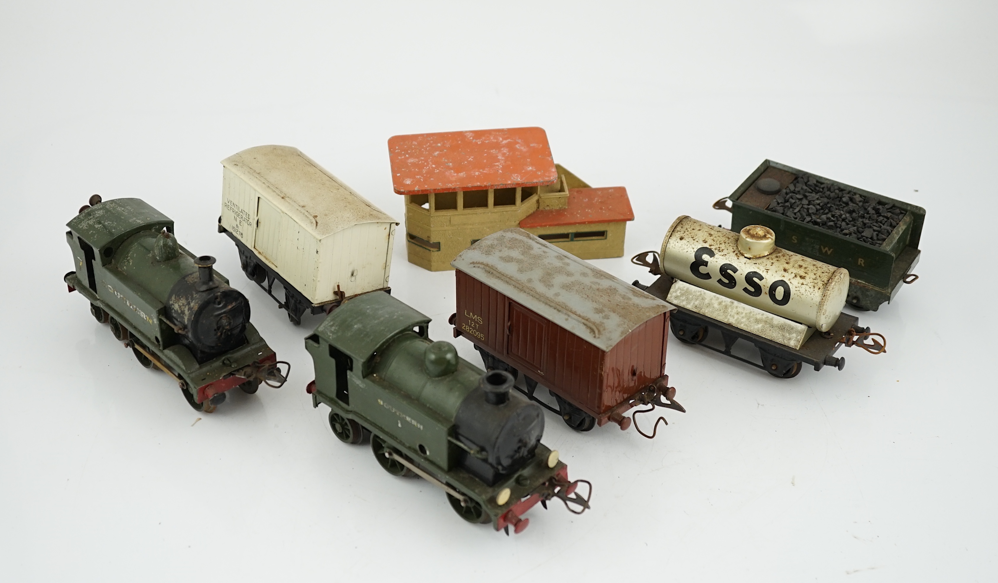 Fourteen 0 gauge tinplate etc. railway items, including three clockwork locomotives; an LSWR 4-4-0 tender loco, an SR 0-4-4T loco and an SR 0-4-2T loco, together with nine Hornby freight wagons, a Bing milk traffic van a